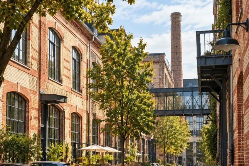 A street with brick buildings, trees, and a bridge. 4