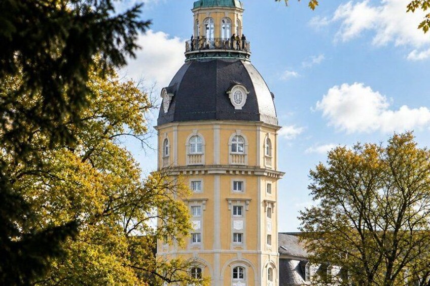 A historic building with a prominent dome and a clock tower. 2