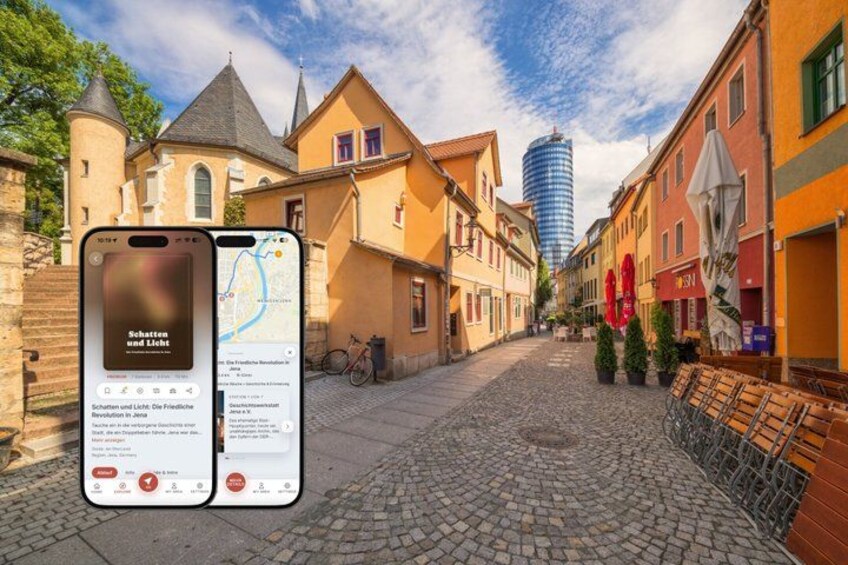 A cobblestone street lined with historic buildings, a church, and a modern skyscraper in the background. 1