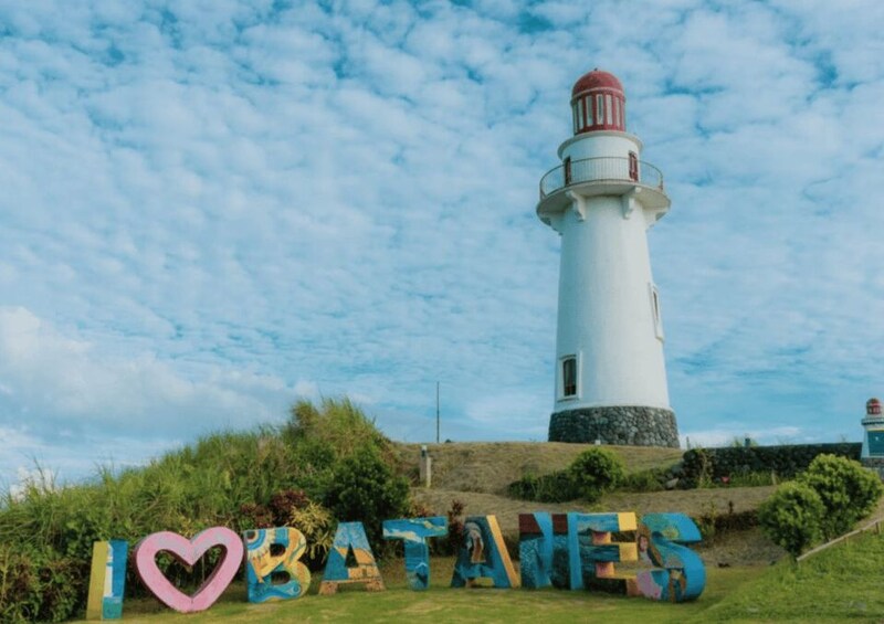 A lighthouse, a grassy hill, and colorful letters spelling 'I LOVE BATANES'. 2