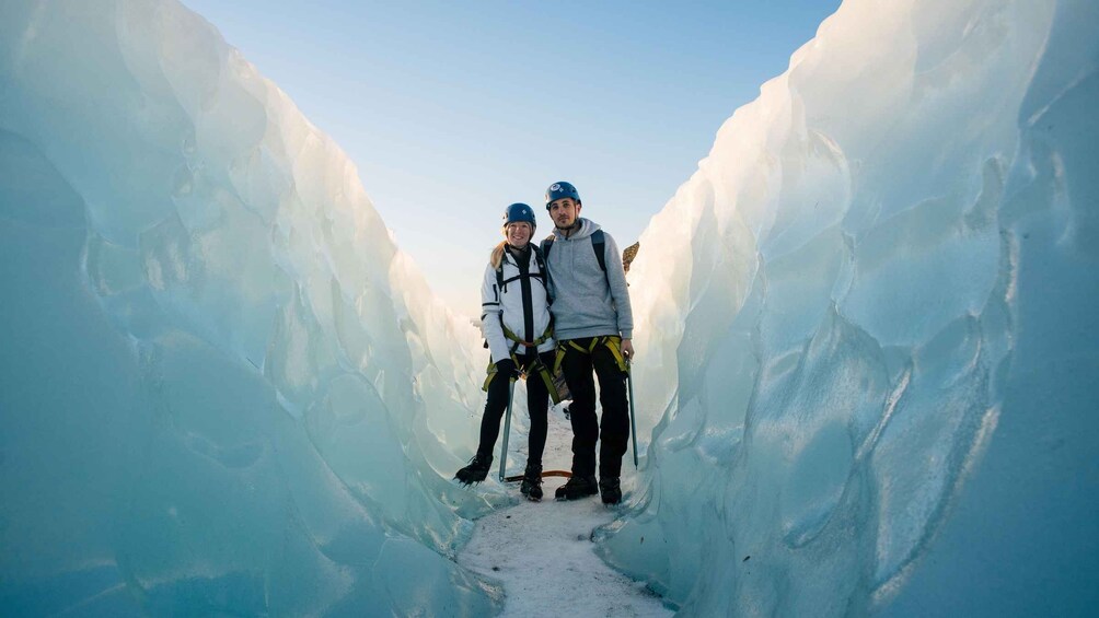 Two people in a narrow ice tunnel. 3