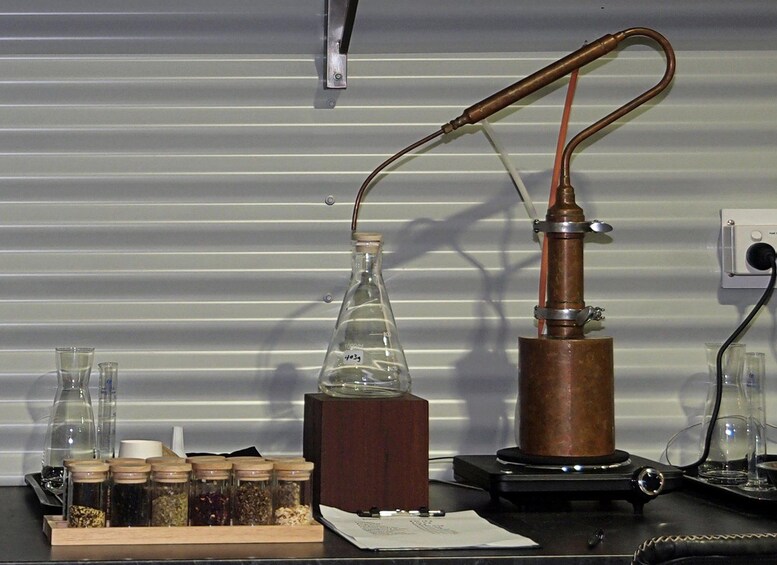 A laboratory setup with a distillation apparatus, a beaker, and various glass containers. 5