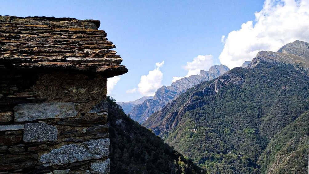 A stone structure with a mountainous landscape in the background. 2