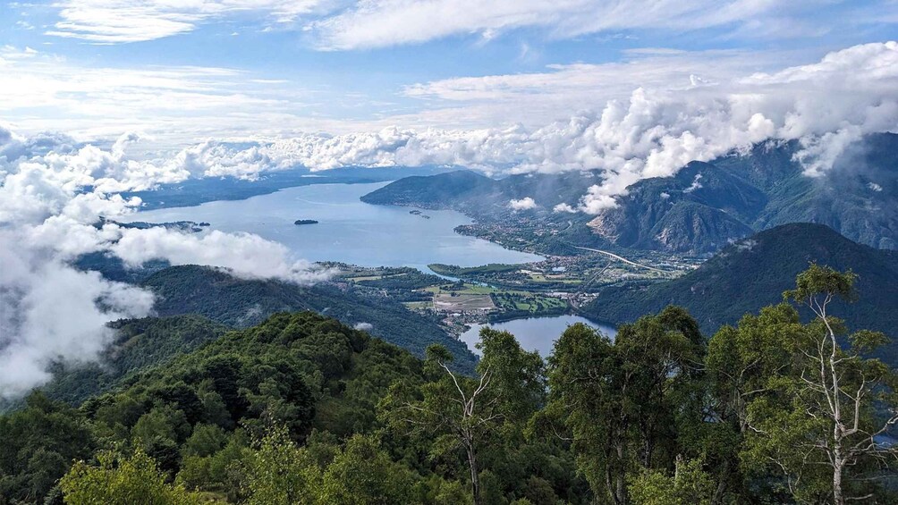 A mountainous landscape with a lake, forested areas, and a bridge. 1