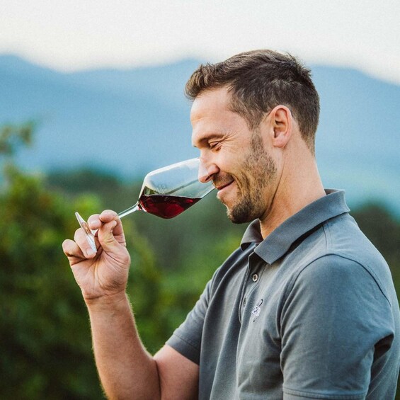 A person holding a wine glass. 1