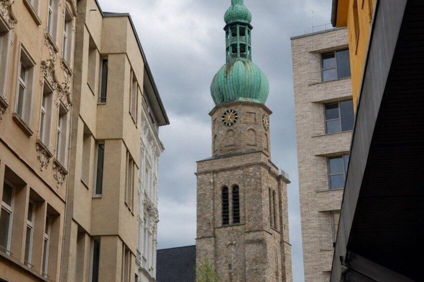 A historic building with a clock tower and a green dome. 4