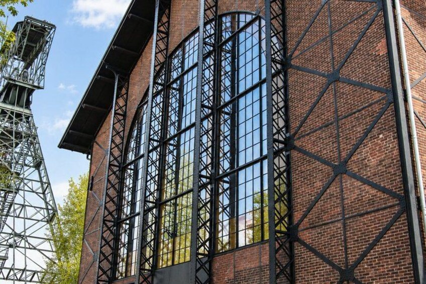 A brick building with large windows and a metal framework. 5