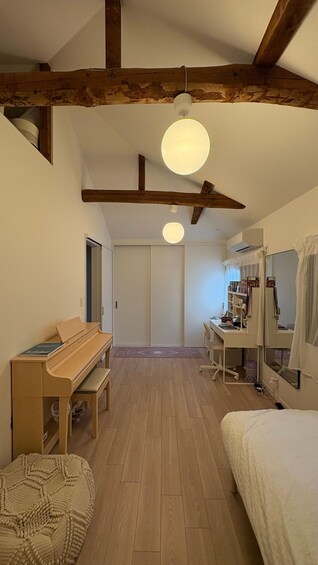 Un dormitorio acogedor con una cama de madera, un escritorio, un piano y un armario. 2