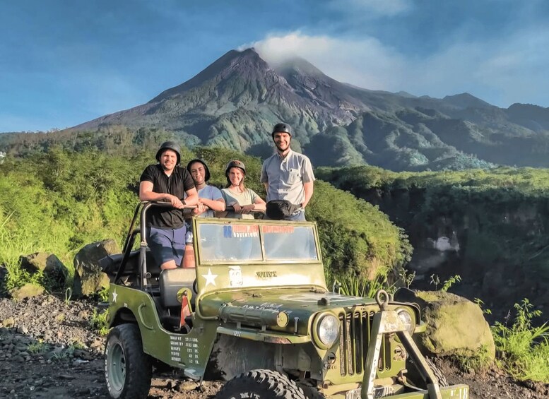 A group of people in a jeep with a mountain in the background. 1