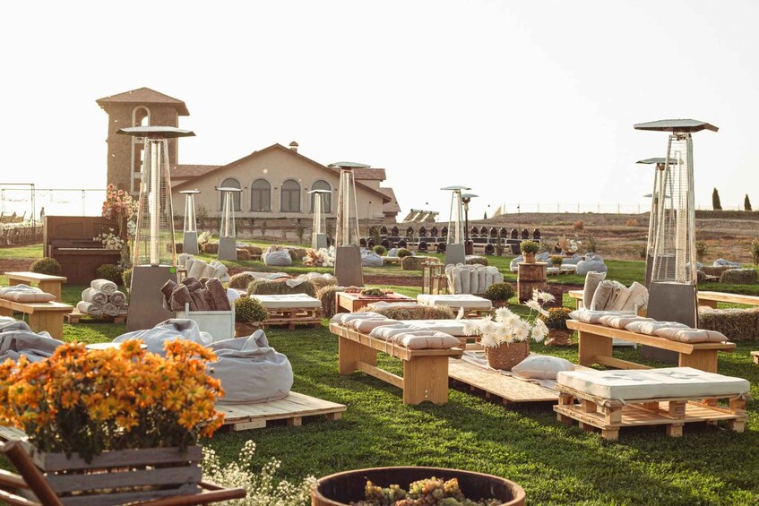 An outdoor event with seating, a piano, and a building in the background. 4