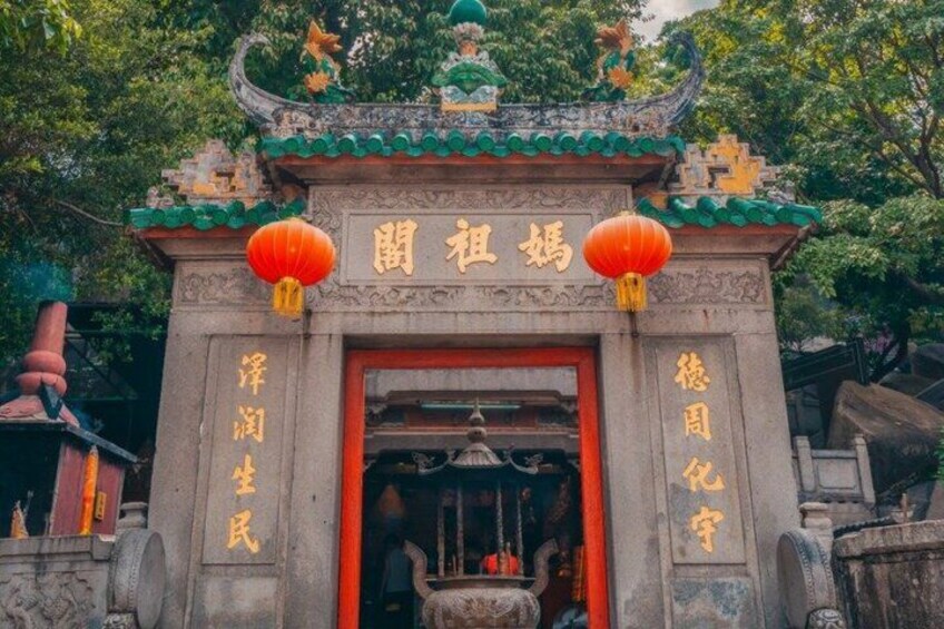 A traditional Chinese gate with ornate decorations and red lanterns. 5