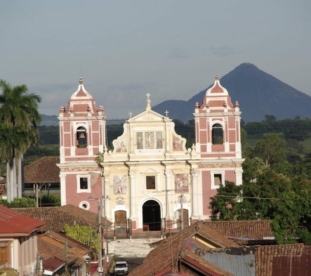 A church with two bell towers and a mountain in the background. 3