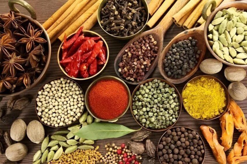 A variety of spices and seeds arranged on a wooden surface. 5