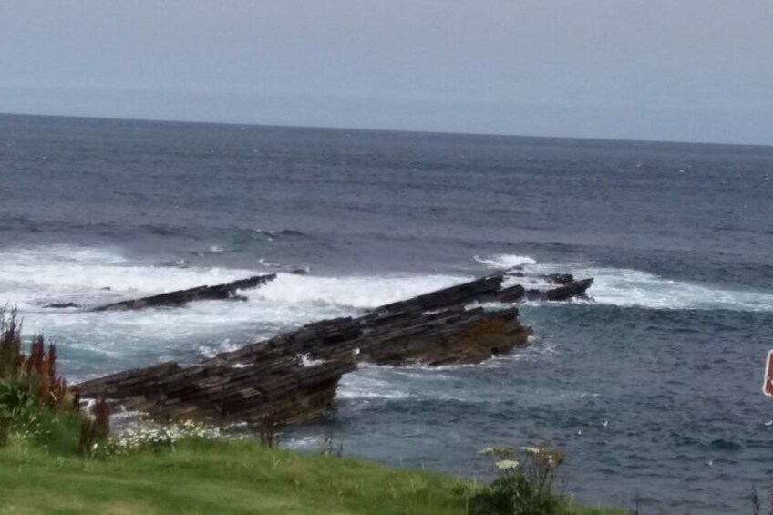 A rocky coastline with waves crashing against the rocks. 2