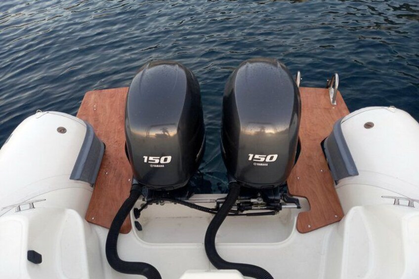 A boat with two Yamaha 150 outboard motors on a wooden deck. 3