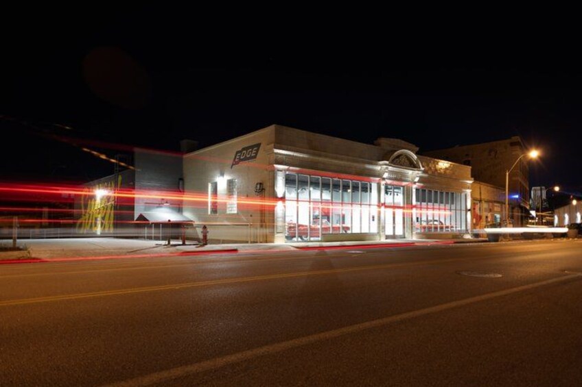 A brightly lit building with a sign that reads 'EDGE' at night. 2