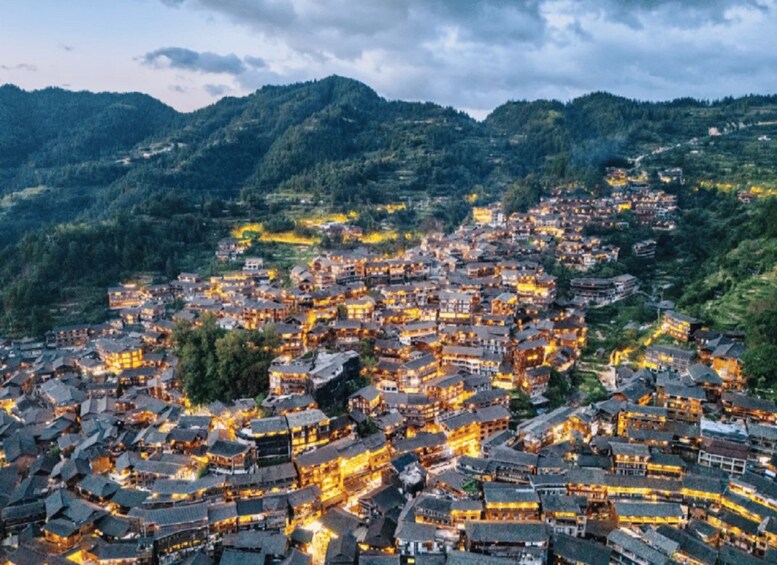 A densely packed village with traditional architecture nestled in a mountainous valley. 5