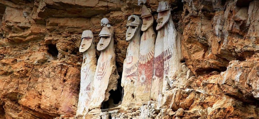 Ancient rock carvings of human figures in a cave. 1