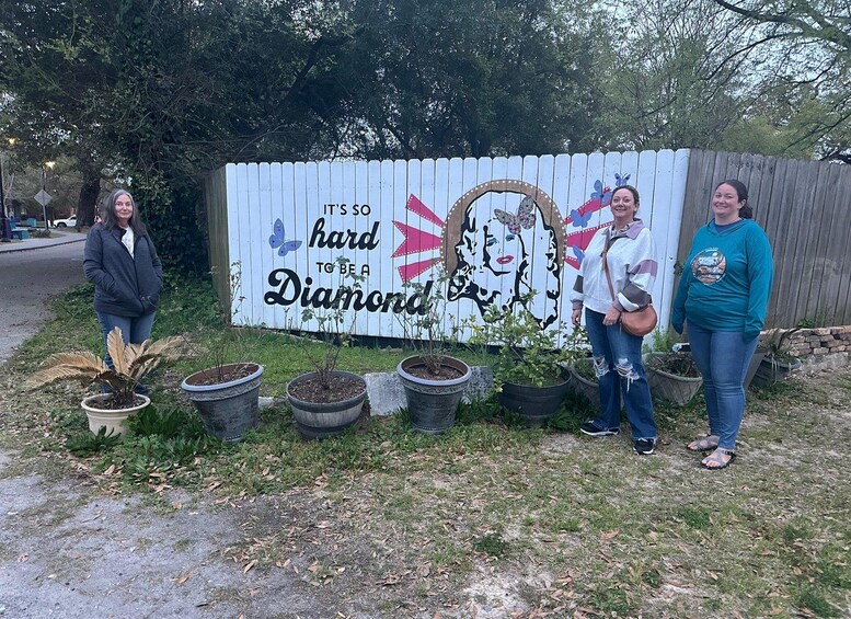 A sign with a diamond theme, surrounded by potted plants. 3