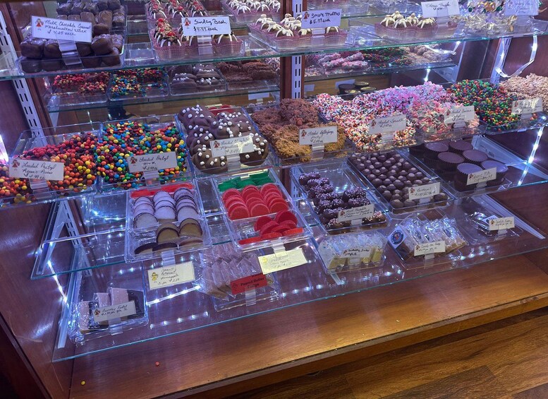 A bakery display case with various baked goods and confections. 4
