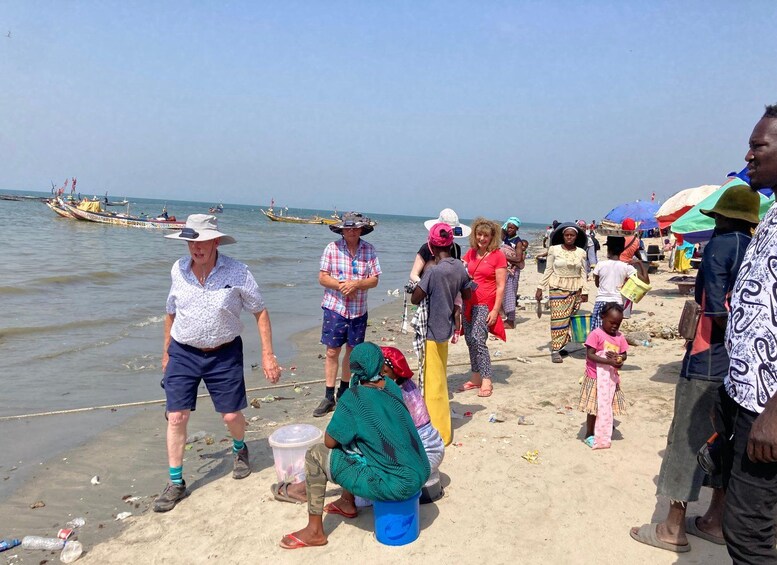 A beach scene with people, boats, and a sandy shore. 3