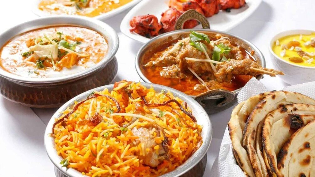 A variety of Indian dishes including biryani, paneer, and tandoori chicken. 5