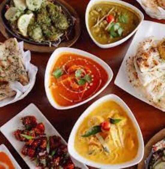 A variety of dishes including a bowl of soup, a plate of flatbread, and a dish with vegetables. 3