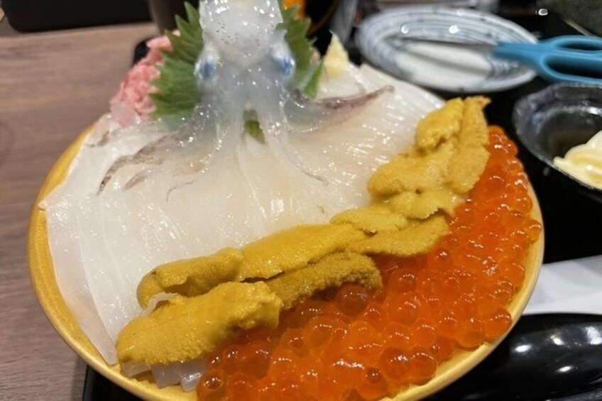 A plate with fish roe, a fish head, and a piece of fish. 4