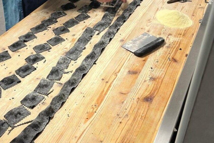 A wooden surface with black rectangular shapes and a yellow powdery substance. 2
