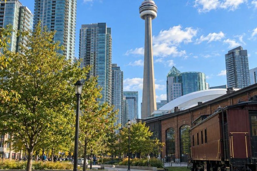 A cityscape with modern high-rise buildings, a prominent tower, and a historic building with a dome. 3