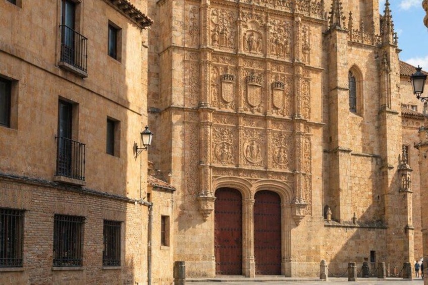 A historic building with ornate carvings and a large wooden door. 4