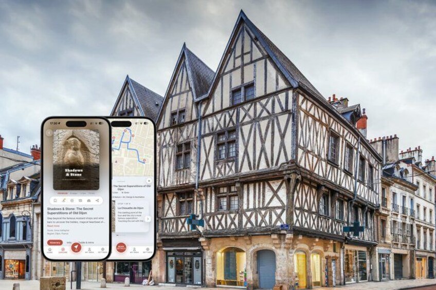 A half-timbered building with a smartphone displaying a map and a book cover. 1