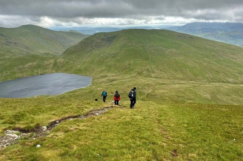 A hiker's path, a lake, and rolling hills. 5