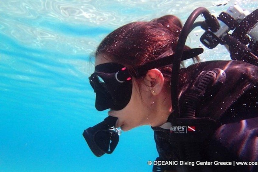 A person underwater with a scuba diving mask and breathing apparatus. 4