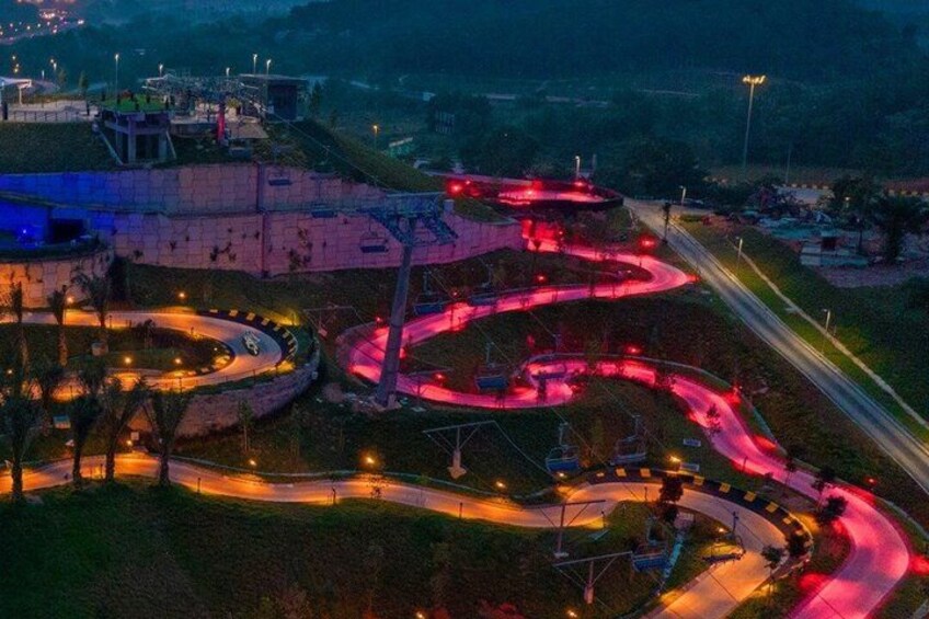 A winding road with multiple curves, surrounded by greenery and buildings. 2