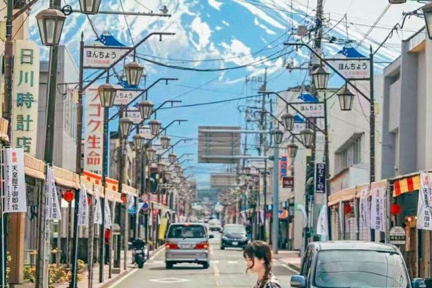 A street with shops, signs, and vehicles. 3
