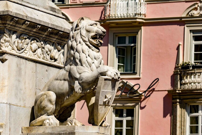 A stone lion statue on a building facade. 5
