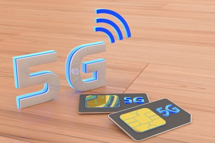 A 5G symbol, a 5G card, and a 5G logo on a wooden surface. 2