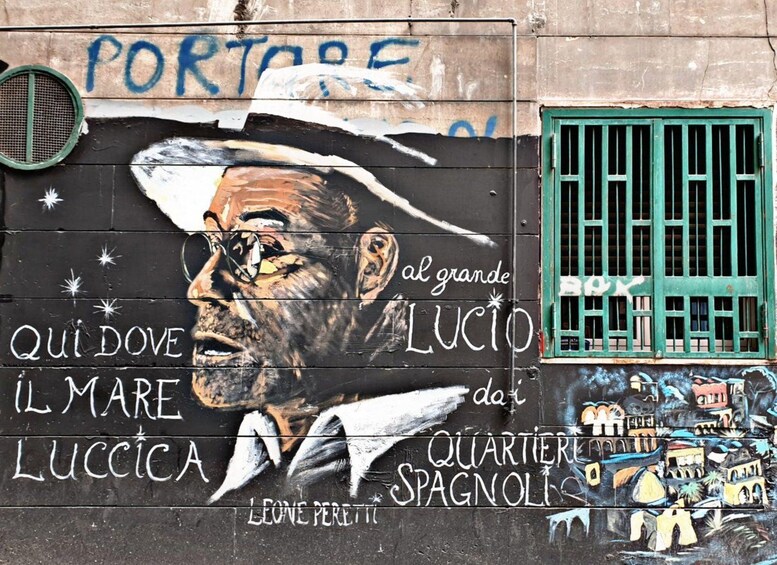 Un mural con el rostro de un hombre, texto y una ventana verde. 2