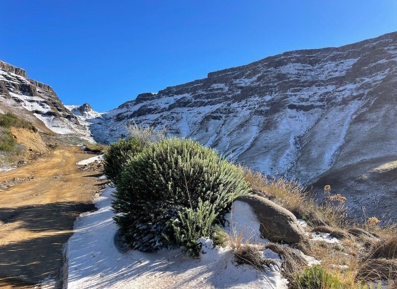 A snow-covered mountain landscape with a clear sky. 3