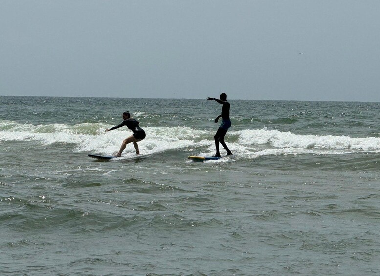 Two people surfing on waves in the ocean. 5