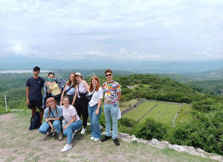 A group of people on a hill overlooking a valley with a clear sky. 4