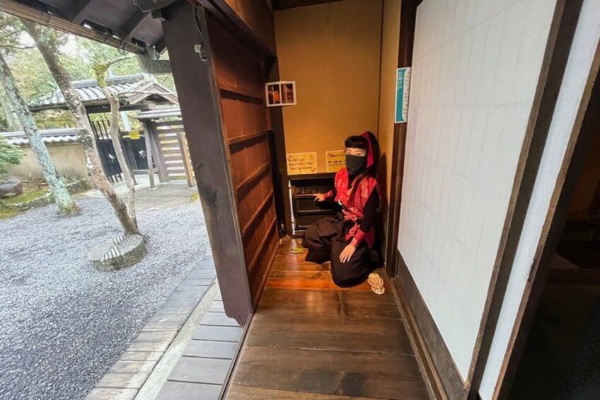 A person sitting on steps inside a building with a traditional Japanese architectural style. 3