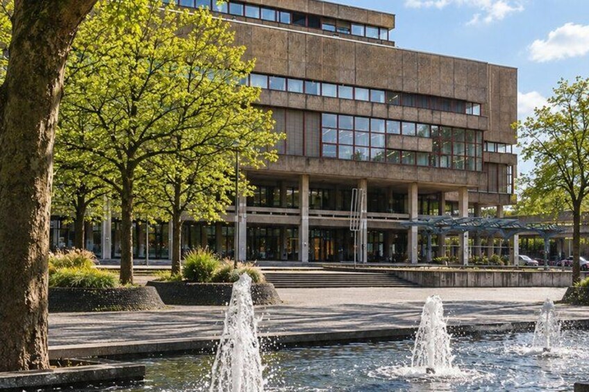 A modern building with a fountain in front. 4