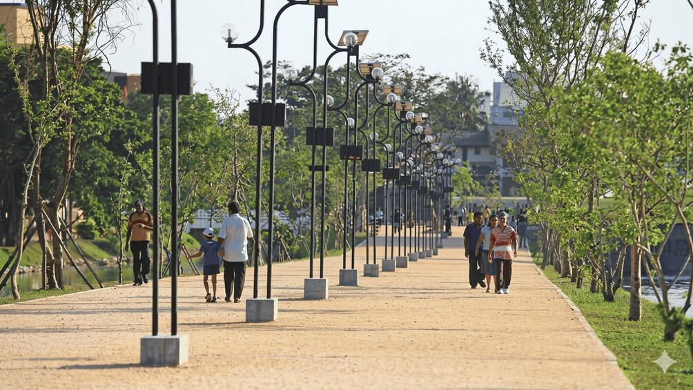 A pathway lined with street lamps and trees, with people walking. 3