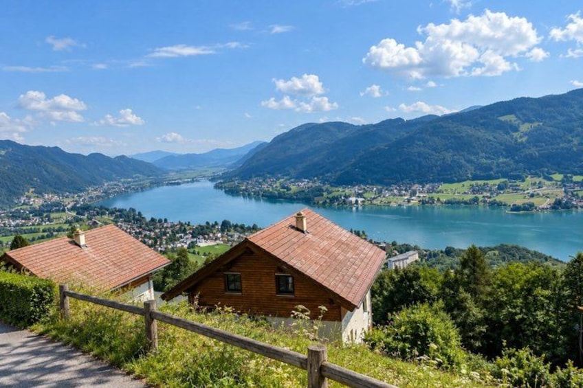 A mountainous landscape with a lake, wooden houses, and a clear sky. 5