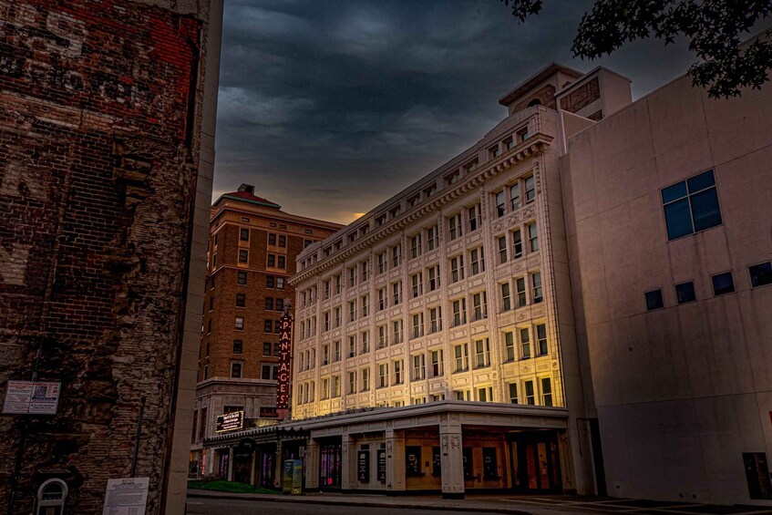 A historic theater building with ornate architecture and a classic marquee. 1