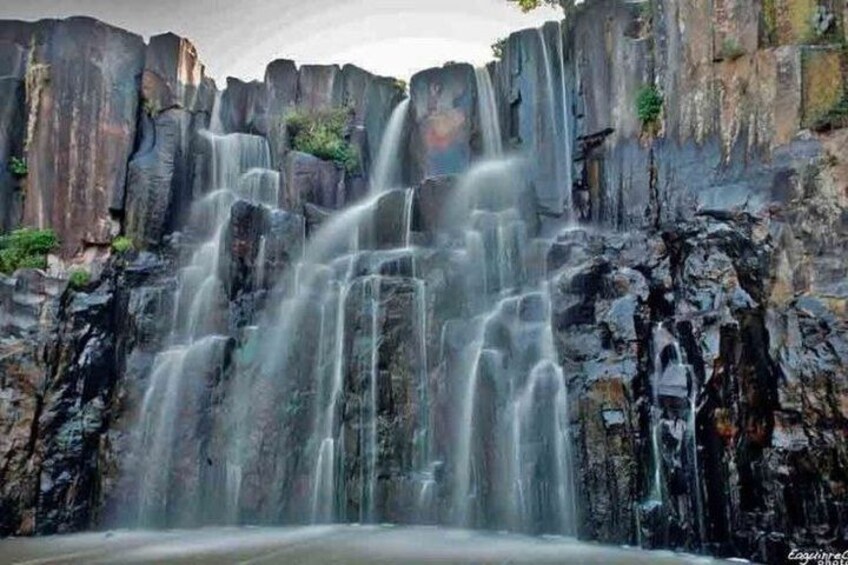A waterfall cascading down a rocky cliff. 3