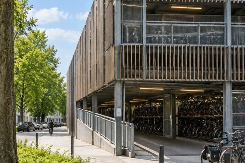A multi-story parking garage with bicycles stored on the upper levels. 4