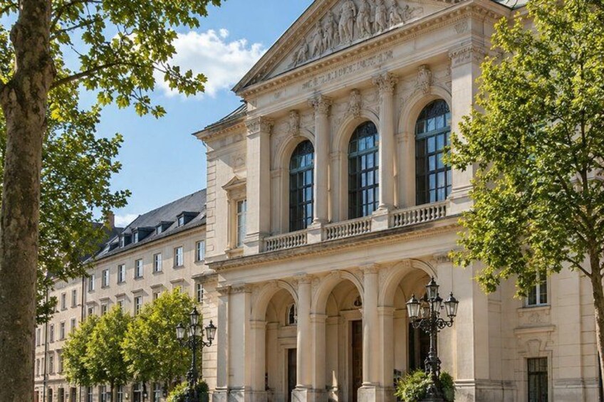 A classical building with columns, arched windows, and a balcony. 4